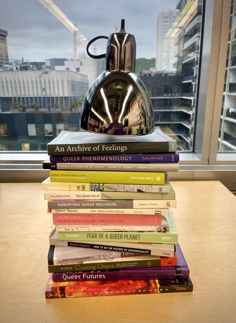 Collection of books from Hanss Lujan Torres' research on the development of queerness in contemporary art.