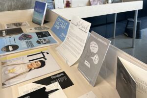 Colour photography showing an exhibition showcase with many documents about Canadian francophonie.
